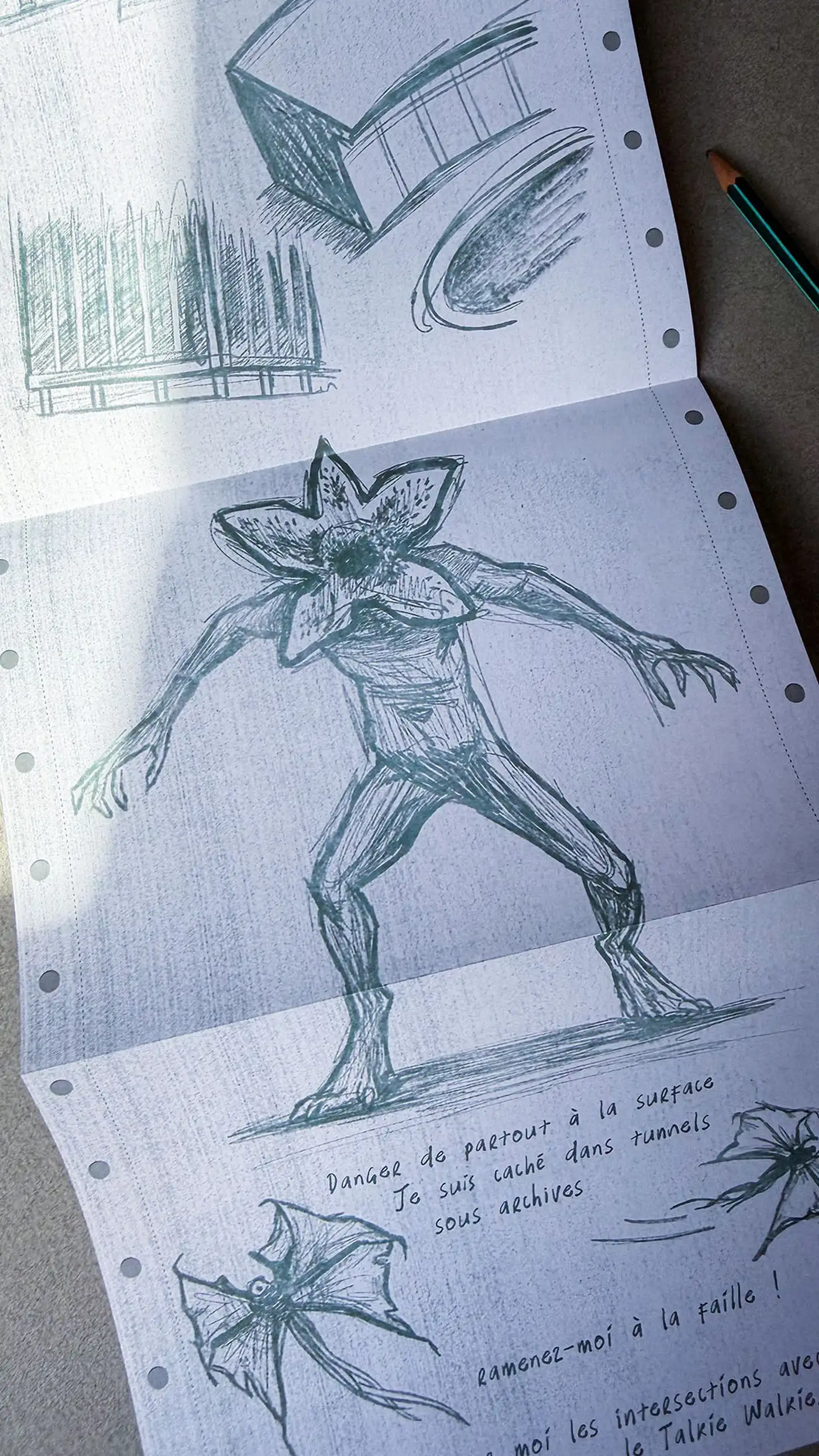 Fanfold printer paper with pencil sketches of the Demogorgon and handwritten warnings